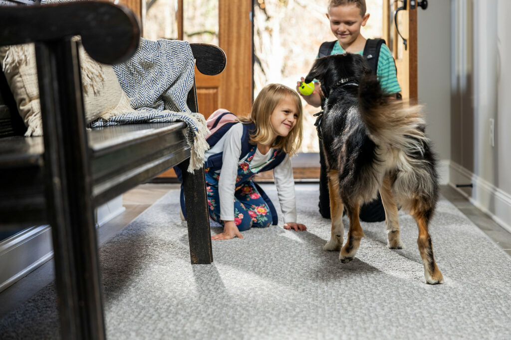 Kids playing with dog | Hopkins Floor Co